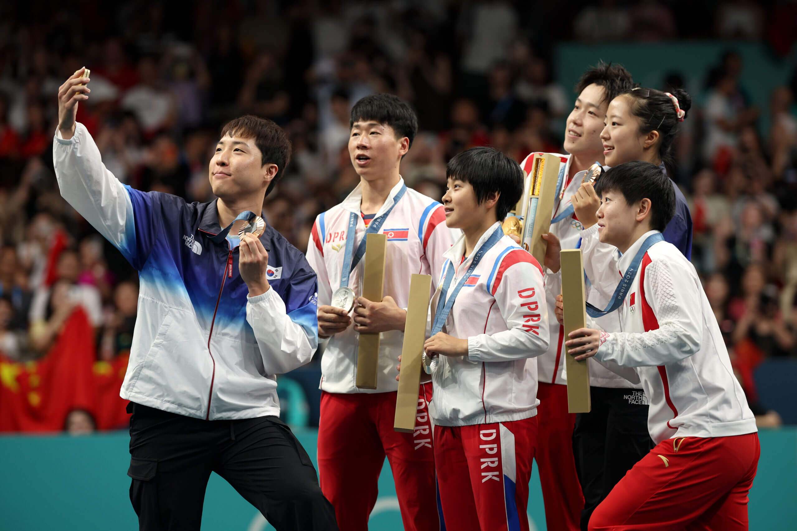 North and South Korea table tennis Olympic medalists pose for shared selfie