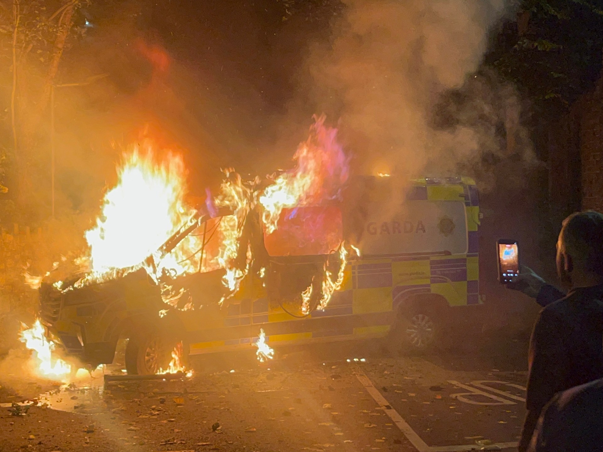 Hundreds of anti-immigrant protesters burn vehicle, attack police in Dublin | Protests News